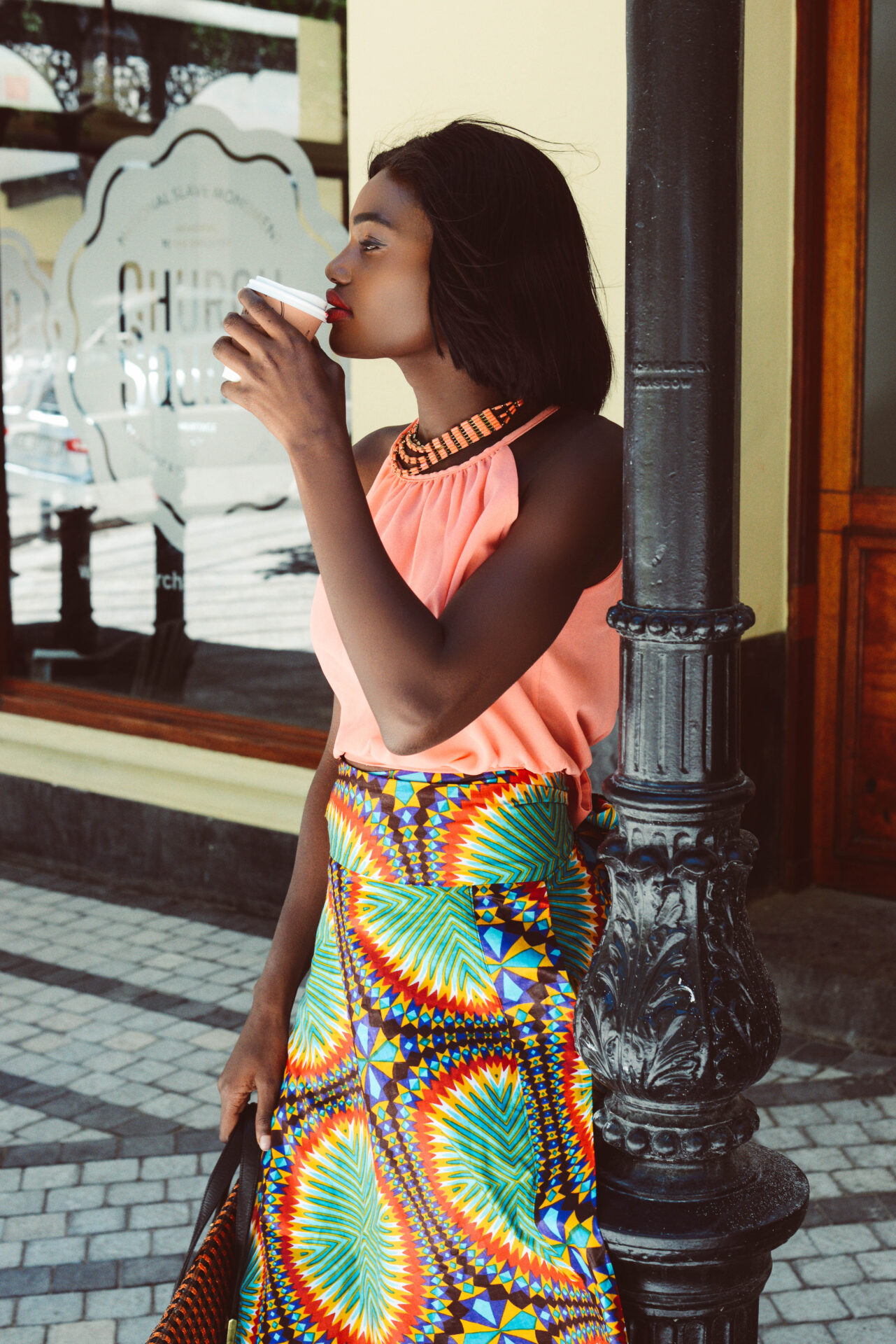Model smiling with coffee at Church Square